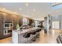 Modern kitchen with a large center island, stainless steel appliances, and sleek cabinetry at 11591 S Maiden Hair Way, Parker, CO 80134