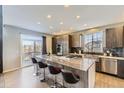 Spacious kitchen with granite countertops, stainless steel appliances, and a view of the deck at 11591 S Maiden Hair Way, Parker, CO 80134