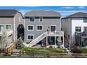 Well maintained backyard with green lawn, deck, stairs, hot tub and privacy fence at 17382 Bluetrail Ave, Parker, CO 80134