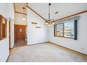 Bright living room showcasing a large window, neutral carpet, and modern lighting at 2275 E 129Th Ave, Thornton, CO 80241