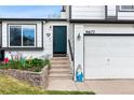 Close-up of a lovely two-story house featuring a well-manicured lawn and a convenient two-car garage at 9677 Castle Ridge Cir, Highlands Ranch, CO 80129