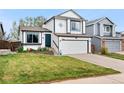 Charming two-story home features a well-manicured lawn, two-car garage, and inviting front entrance at 9677 Castle Ridge Cir, Highlands Ranch, CO 80129