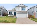 Charming two-story home features a well-manicured lawn, two-car garage, and inviting front entrance at 9677 Castle Ridge Cir, Highlands Ranch, CO 80129