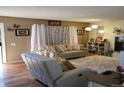 Relaxing living room with light-colored furniture and hardwood floors at 1227 S Uvalda St, Aurora, CO 80012