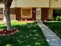 Attractive home exterior with well-manicured lawn and walkway at 1227 S Uvalda St, Aurora, CO 80012