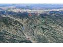 An aerial view pinpoints 79 Beaver Rd in a mountainous region with views of Downtown Idaho Springs at 79 Beaver Rd, Idaho Springs, CO 80452