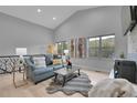 Bright living room featuring vaulted ceilings, large windows, and a cozy fireplace at 79 Beaver Rd, Idaho Springs, CO 80452