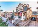 Charming two-story home with a welcoming front porch and an American flag at 537 N Logan St, Denver, CO 80203
