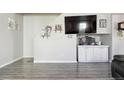 Cozy living room with built-in storage, gray wood floors, and decorative wall shelves at 765 Mockingbird St, Brighton, CO 80601