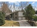 Charming two-story brick home with a well-manicured lawn and a two-car garage at 2492 S Yarrow St, Lakewood, CO 80227