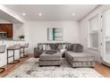 Bright living room with plush seating, hardwood floors, and natural light from the large windows at 19 S Harrison St, Denver, CO 80209