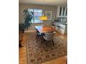Inviting dining area with wood table, modern light fixture, and decorative rug at 701 S Clayton St, Denver, CO 80209