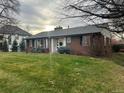 Ranch style brick home with a spacious lawn at 701 S Clayton St, Denver, CO 80209