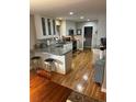 Modern kitchen featuring gray countertops and white cabinets at 701 S Clayton St, Denver, CO 80209