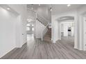 Bright entryway featuring a staircase with iron balusters and stylish gray-toned wood flooring at 301 Amethyst Way, Superior, CO 80027