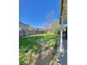 Expansive backyard featuring a well-maintained lawn, wooden fence, and partial covered patio at 13024 E Alaska Pl, Aurora, CO 80012