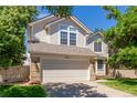 Beautiful two-story home with a manicured lawn and an attached two-car garage at 10707 Jordan Ct, Parker, CO 80134