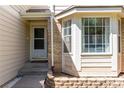 Inviting front entrance with a bay window, brick accents, and a well-maintained walkway at 10707 Jordan Ct, Parker, CO 80134