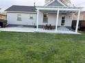 Spacious backyard featuring a covered patio with outdoor dining set, perfect for entertaining or relaxation at 2728 N Yates St, Denver, CO 80212
