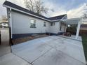 Exterior of the house showcasing a concrete patio with pergola and outdoor dining area and mature landscaping at 2728 N Yates St, Denver, CO 80212