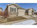 A single-Gathering home with a two-car garage and a well-maintained front yard at 529 Vista Blvd, Lochbuie, CO 80603