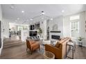 Open floor plan with hardwood floors, brick fireplace, contemporary lighting, and a comfortable living space at 11027 Sunshimmer Cir, Parker, CO 80134