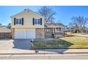 Charming two-story home with a two-car garage, brick accents, well-maintained lawn, and mature trees at 5927 S Kline St, Littleton, CO 80127