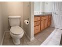 Well-lit bathroom with a toilet and wood vanity with granite counter at 935 N Pennsylvania St # 3, Denver, CO 80203