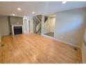 Spacious living room with wood flooring, fireplace, staircase and entry to other rooms at 935 N Pennsylvania St # 3, Denver, CO 80203