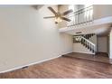 Spacious living room with vaulted ceiling, hardwood floors, and a loft area at 11733 Elk Head Range Rd, Littleton, CO 80127