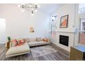 Bright living room featuring a cozy fireplace and comfortable sectional sofa at 11860 Sandcastle Ct, Parker, CO 80138