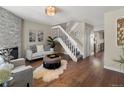 Inviting living room boasts a fireplace, hardwood floors, and staircase to the second level at 9676 W Chatfield Ave # B, Littleton, CO 80128