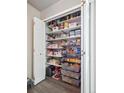 Well-stocked pantry with organized shelving and clear containers, ensuring ample storage space at 10961 Main Range Trl, Littleton, CO 80127