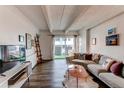Comfortable living room with a large sectional sofa, balcony access, and stylish decor at 1265 Race St # 408, Denver, CO 80206