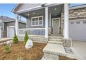 Inviting front porch with white columns and room for seating at 6711 Fraser Cir, Frederick, CO 80530