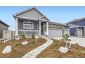 Beautifully landscaped front yard with a stone walkway leading to a covered porch at 6711 Fraser Cir, Frederick, CO 80530