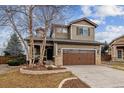 Charming two-story home featuring a well-maintained front yard and attached two-car garage at 10358 Kelliwood Way, Highlands Ranch, CO 80126