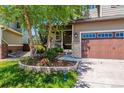 Charming two-story home featuring well-maintained landscaping, a two-car garage and a beautiful tree in the front yard at 10358 Kelliwood Way, Highlands Ranch, CO 80126