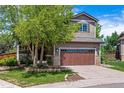 Charming two-story home featuring well-maintained landscaping, a two-car garage and a beautiful tree in the front yard at 10358 Kelliwood Way, Highlands Ranch, CO 80126