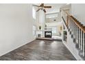 Spacious living room with a fireplace, high ceilings, and wood-look floors, creating an inviting space at 4865 Gibraltar St, Denver, CO 80249