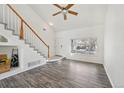 Inviting living room featuring wood-look floors, a staircase, and large windows, creating an airy space at 4865 Gibraltar St, Denver, CO 80249