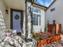 Inviting front entrance features a decorative wreath, stylish address numbers, and well-maintained landscaping at 718 Fairhaven St, Castle Rock, CO 80104