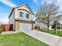 Two-story home featuring a spacious driveway, manicured lawn, and attached two-car garage at 718 Fairhaven St, Castle Rock, CO 80104