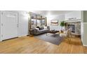 Bright living room featuring hardwood floors and a cozy stone fireplace at 9360 Lowell Blvd, Westminster, CO 80031