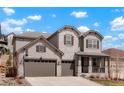 Charming two-story home with a three-car garage, stone accents, and a well-manicured front yard at 13034 Bridge View Ln, Parker, CO 80134