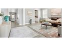 Bright living room featuring neutral walls, wood floors, and a leather sofa at 13034 Bridge View Ln, Parker, CO 80134