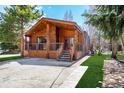 Log cabin-style home with striking wooden beams, a red front door, and a well-manicured lawn at 85 Revett Dr # 66, Breckenridge, CO 80424