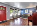 Inviting living room featuring hardwood floors, ample natural light, and a cozy ambiance at 1215 S Ivanhoe Way, Denver, CO 80224