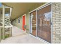 Patio exterior with slider and red door at unit, and walkway access at 695 Manhattan Dr # 109, Boulder, CO 80303
