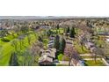 Expansive aerial shot showcasing a single story home near a lush golf course and tree-lined neighborhood streets at 16 Wedge Way, Littleton, CO 80123